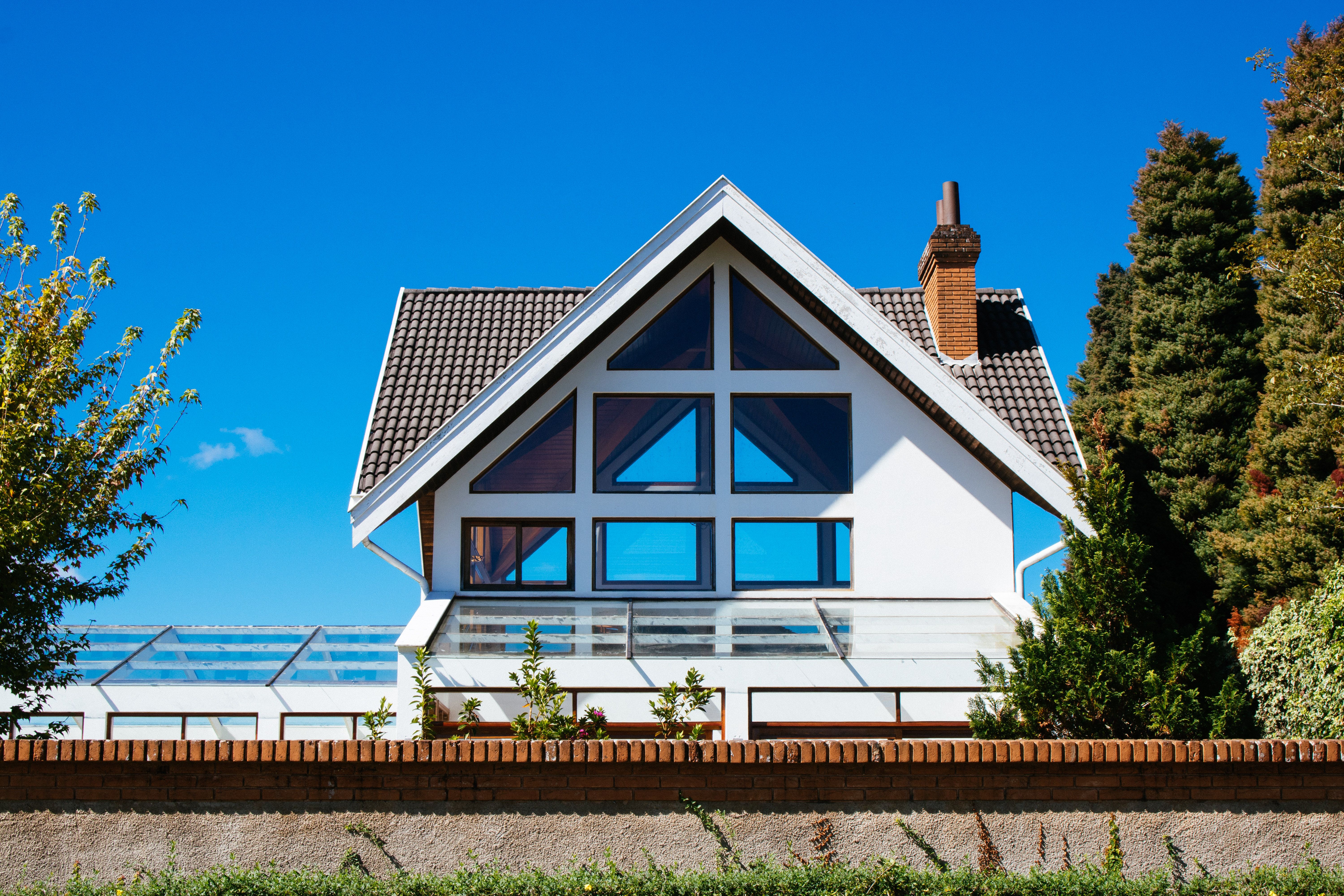 Contemporary home with a steep tiled roof and large architectural windows